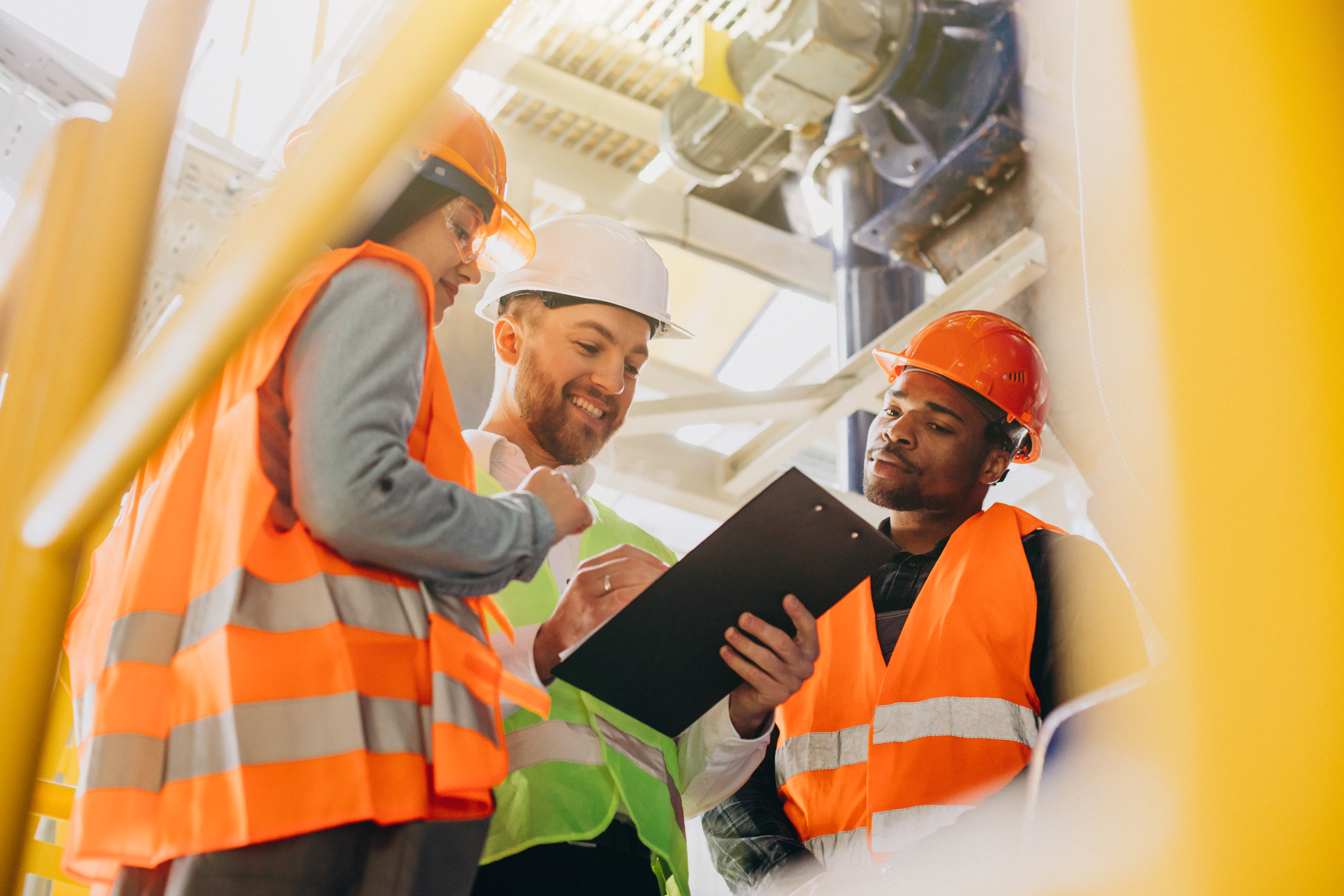 Construction workers reviewing OSHA training checklist for California construction site safety compliance